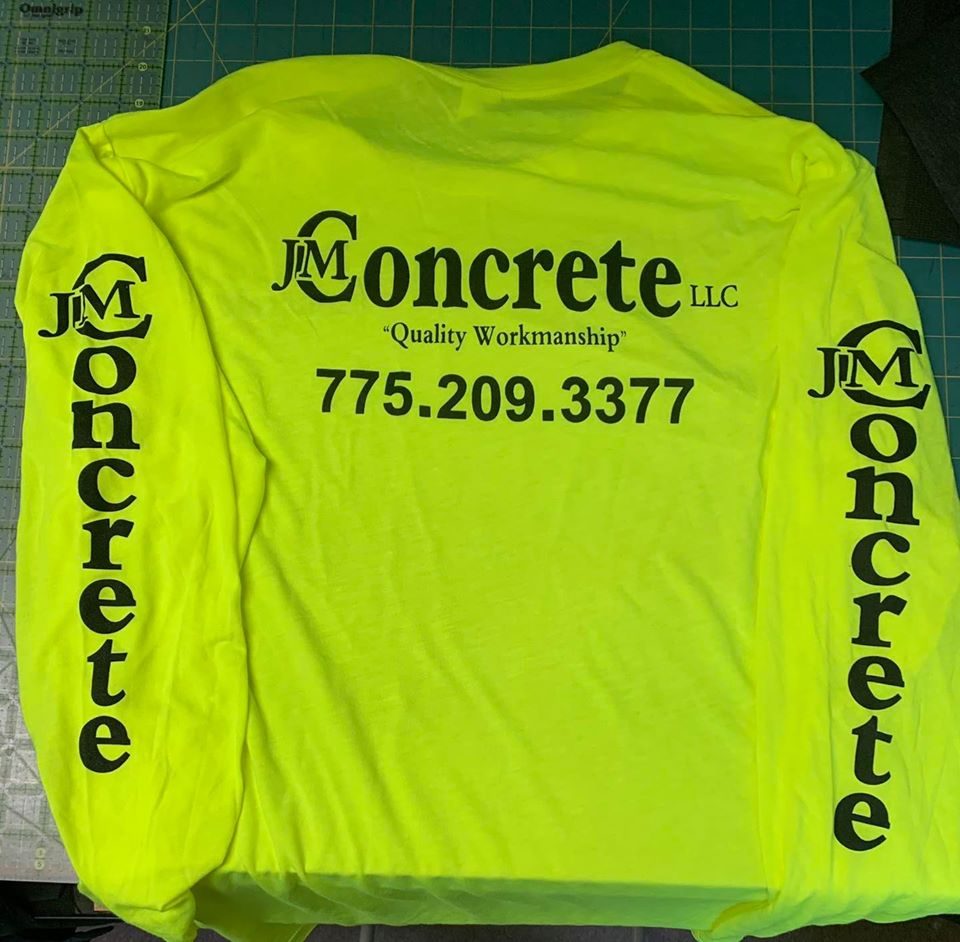 Hi-vis yellow long sleeve shirt printed with the JM Concrete logo and phone number down both sleeves