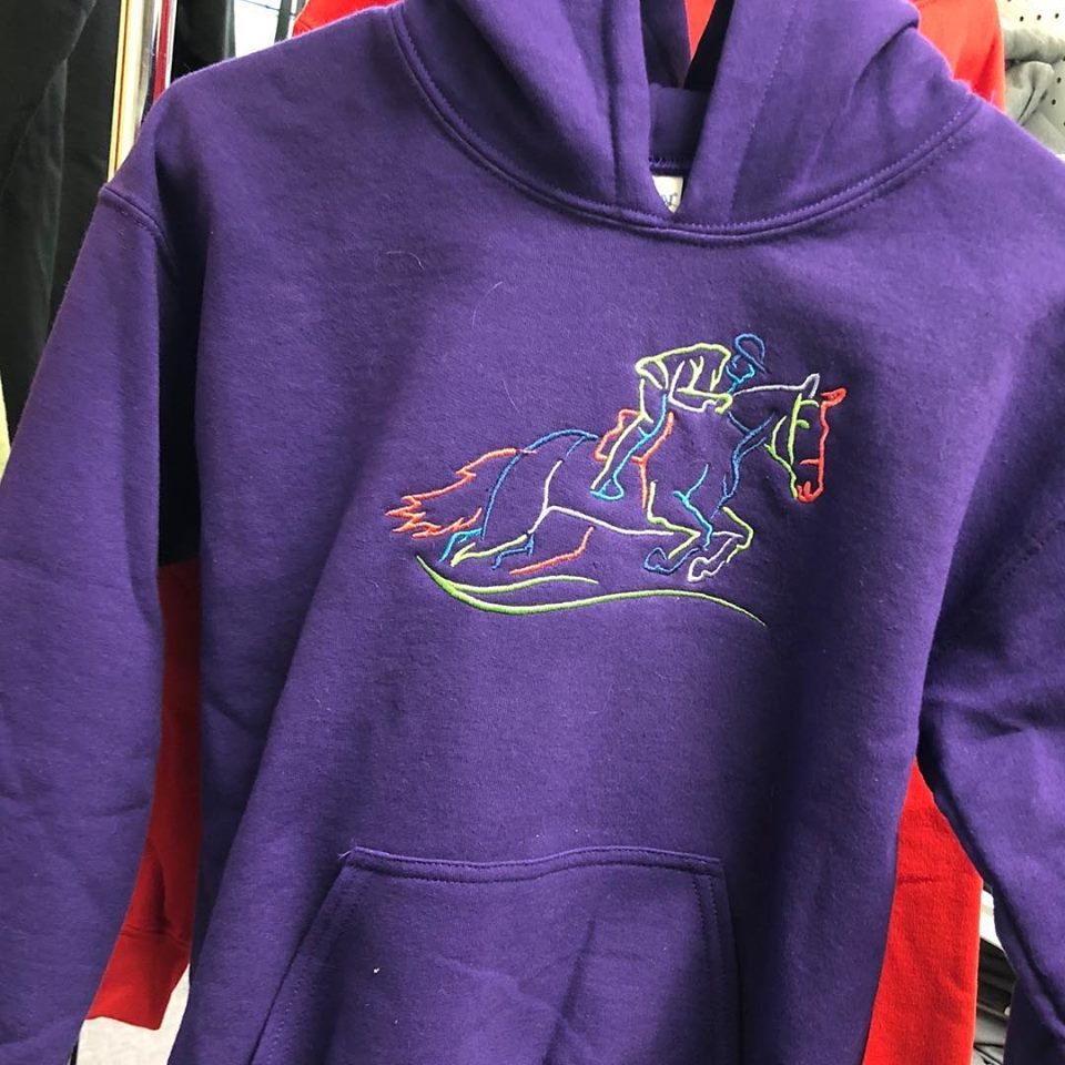 Purple hoodie with a multi-color embroidered horse and rider design