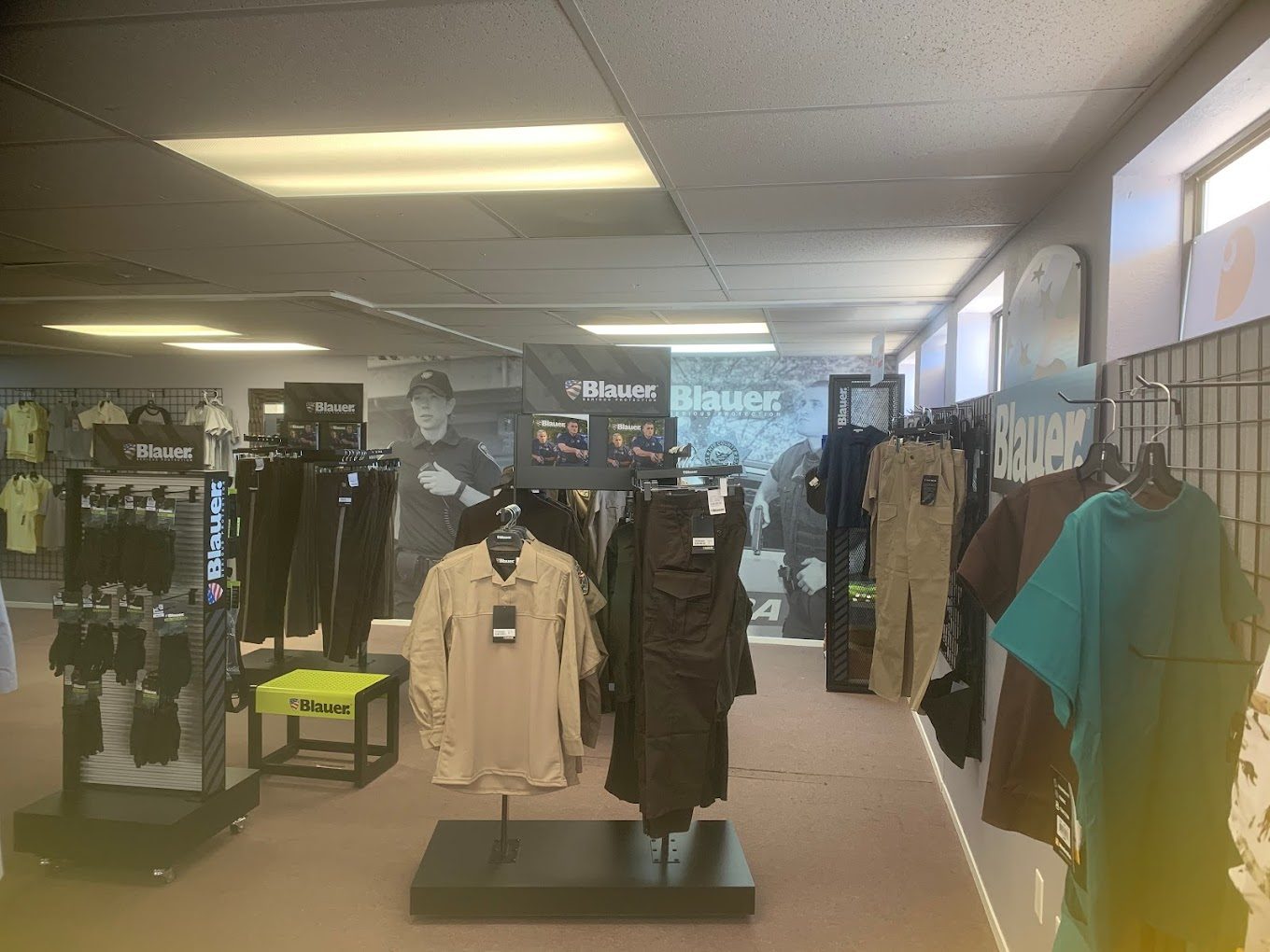 Inside the Hubbster showroom in Pahrump with racks of jackets, uniforms and decorated apparel