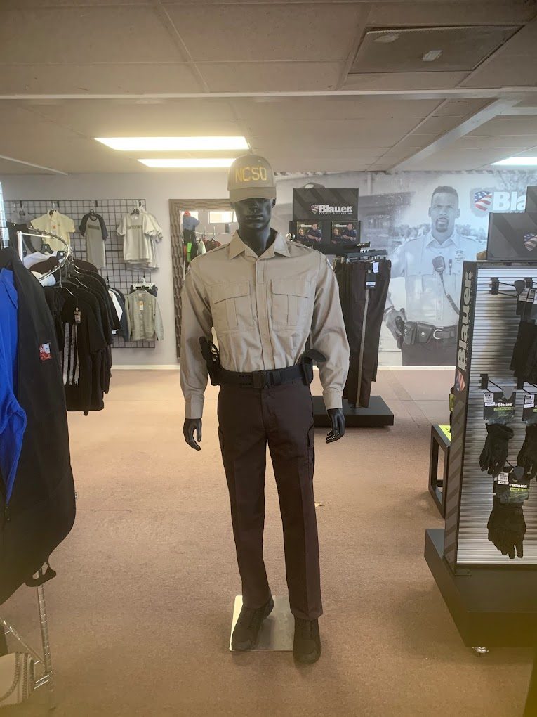 Mannequin in a pressed uniform shirt and slacks on the Hubbster sales floor